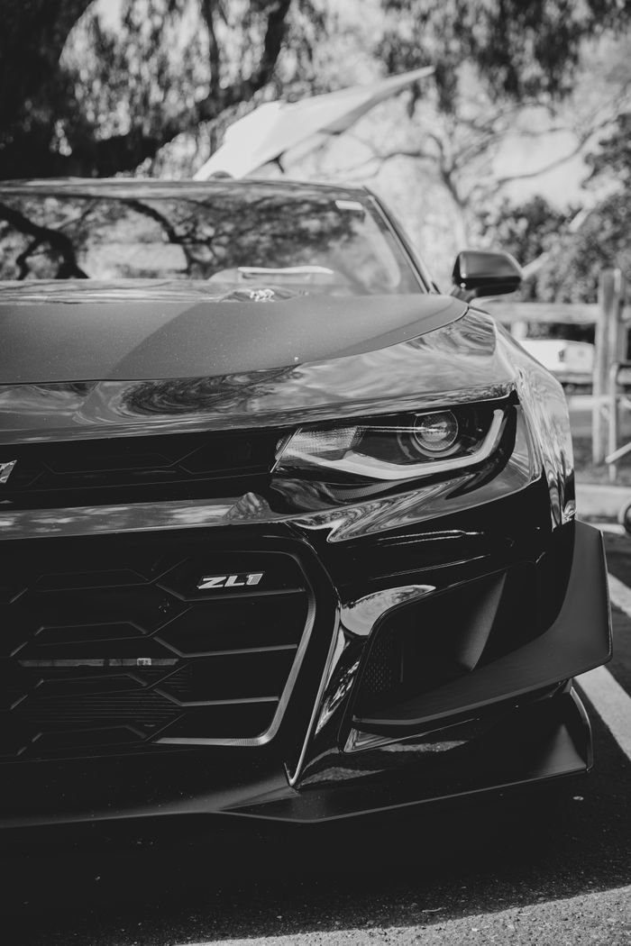 Artistic black and white close-up of a Chevrolet Camaro ZL1 showcasing its sleek design.